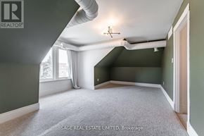 Hamilton (Kirkendall) apartment for rent - A room with a carpet floor and a window with white curtains.