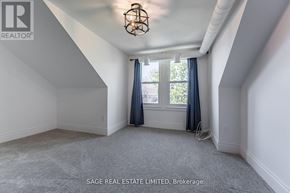Hamilton (Kirkendall) apartment for rent - A room with a window and curtains, and a chandelier hanging from the ceiling.