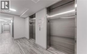 Waterloo condo for rent - A hallway with a realtor sign on the wall.