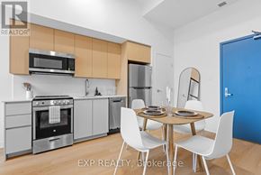 Ottawa multi-family for rent - A bedroom with a bed, desk, and clothing rack.