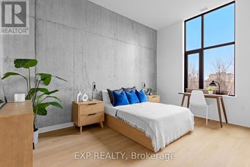 Ottawa multi-family for rent - A living room with a grey couch and a painting on the wall.