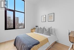 Ottawa multi-family for rent - A realtor is standing in a room with a fireplace and a woman is sitting on a couch.