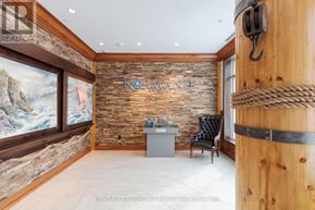 Ottawa condo for rent - A room with a stone wall and a sign that says "NORAMAND".