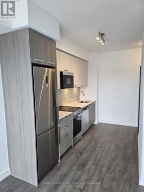 Hamilton (Corktown) condo for rent - A room with green walls and a row of chairs.