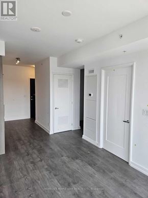 Hamilton (Corktown) condo for rent - A white bathroom with a toilet, sink, and shower.