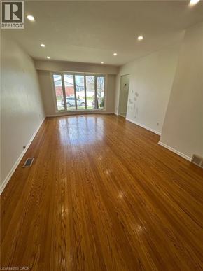Hamilton apartment for rent - A room with wooden flooring and a sliding glass door.