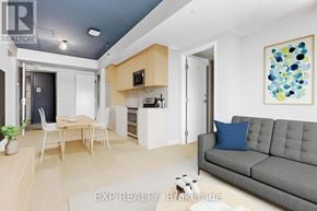 Ottawa apartment for rent - A living room with a grey couch and a painting on the wall.