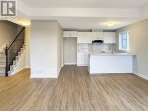 Ottawa townhouse for rent - A spacious kitchen with a staircase on the left side.