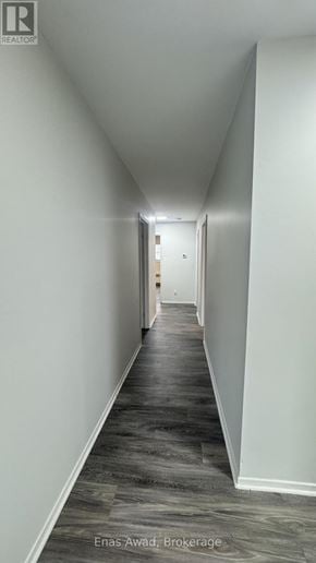 Ottawa triplex for rent - A long hallway with wood floors and white walls.
