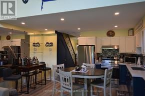 Ramara (Brechin) townhouse for rent - A kitchen with a dining table and chairs.