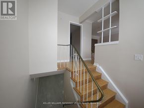 Toronto (Glenfield-Jane Heights) apartment for rent - A staircase with a wooden handrail and a glass door at the bottom.