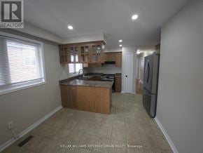 Toronto (Glenfield-Jane Heights) apartment for rent - A kitchen with a refrigerator, sink, and cabinets.