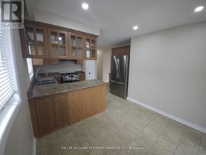 Toronto (Glenfield-Jane Heights) apartment for rent - A kitchen with wooden cabinets and a refrigerator.