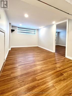 Burlington (Appleby) apartment for rent - A room with wooden flooring and white walls.