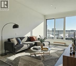 Kitchener condo for rent - A living room with a grey couch and a coffee table.