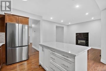 Ottawa apartment for rent - A kitchen with white cabinets and a stainless steel refrigerator.