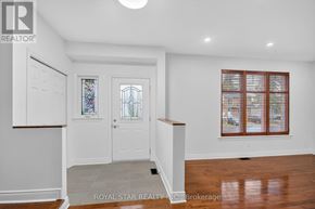 Ottawa apartment for rent - A white door with a glass window is in the middle of a room.