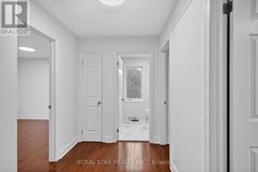 Ottawa apartment for rent - A white hallway with a door and a window.