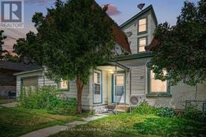 Smiths Falls apartment for rent - A house with a blue door and a tree in front of it.