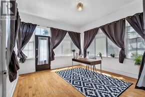 Smiths Falls apartment for rent - A room with a wooden floor and a rug in the middle.