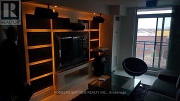 Toronto (York University Heights) condo for rent - A living room with a television and a glass table.