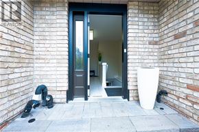 Ancaster apartment for rent - A doorway with a glass door and a plant inside.