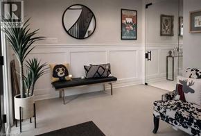 Waterdown apartment for rent - A living room with a bench, a couch, and a potted plant.