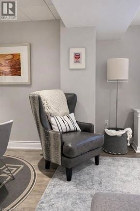 Waterdown apartment for rent - A grey chair with a white pillow and a grey blanket is in the foreground.
