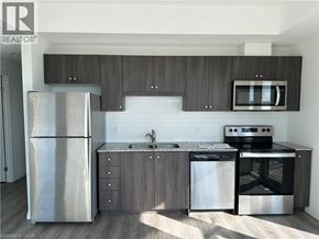 Kitchener condo for rent - A modern kitchen with a stainless steel refrigerator, microwave, oven, and dishwasher.