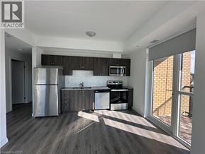 Kitchener condo for rent - A modern kitchen with a refrigerator, microwave, and dishwasher.