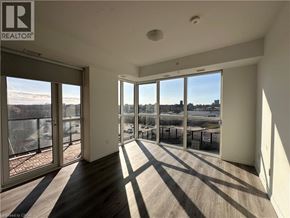Kitchener condo for rent - A sunny day in a spacious room with a view of the cityscape.