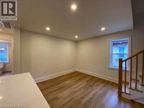 Stratford apartment for rent - A room with wooden floors and a window with a view of buildings outside.