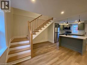 Stratford apartment for rent - A wooden staircase leads to a kitchen area with a countertop.