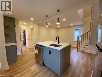 Stratford apartment for rent - A kitchen with a sink and a refrigerator in a house.