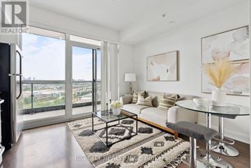 Toronto (Thorncliffe Park) condo for rent - A living room with a glass table and a sofa.