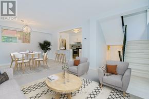 Toronto (East End-Danforth) apartment for rent - A living room with a grey couch, a wooden coffee table, and a dining table with chairs.