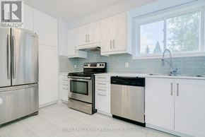 Toronto (East End-Danforth) apartment for rent - A kitchen with white cabinets and stainless steel appliances.