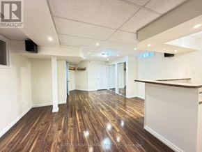 Richmond Hill (Westbrook) apartment for rent - A spacious room with wooden flooring and white walls, likely a commercial space.