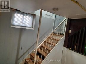 Barrie (Wellington) apartment for rent - A staircase in a room with a window and a sign that says "SAVE MAX SUPERSTARS, Brokerage".
