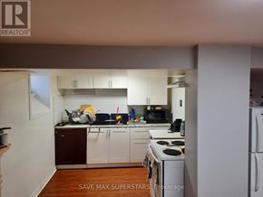 Barrie (Wellington) apartment for rent - A kitchen with white appliances and wooden floors.
