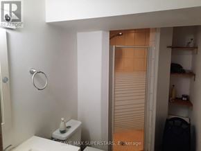 Barrie (Wellington) apartment for rent - A bathroom with a toilet, sink, and a door leading to a closet.