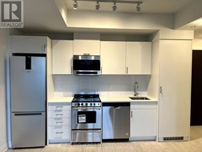 Oakville (Jm Joshua Meadows) condo for rent - A modern kitchen with white cabinets and stainless steel appliances.