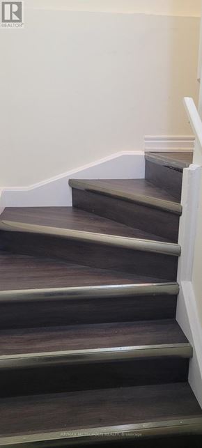 Toronto (O'connor-Parkview) townhouse for rent - A set of stairs with a white railing.