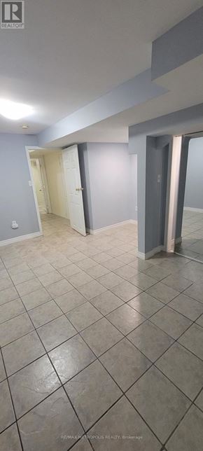 Toronto (O'connor-Parkview) townhouse for rent - A room with a tiled floor and a doorway leading to another room.