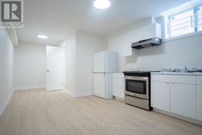 Toronto (Englemount-Lawrence) apartment for rent - A kitchen with white appliances and cabinets is for sale.