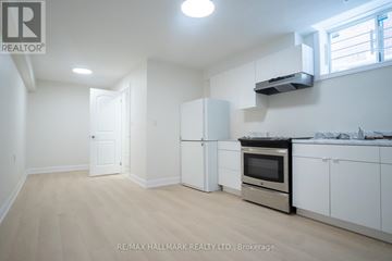 Toronto (Englemount-Lawrence) apartment for rent - A kitchen with white appliances and cabinets is for sale.