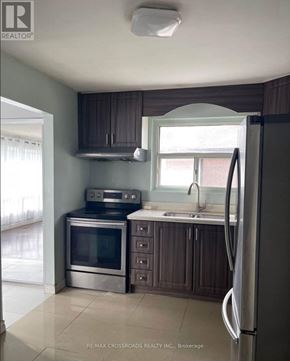 Toronto (Malvern) apartment for rent - A kitchen with a refrigerator, oven, and microwave.