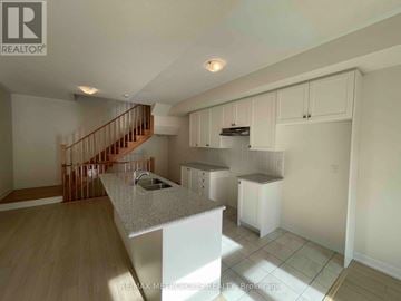 Richmond Hill townhouse for rent - A kitchen with a counter top and cabinets.