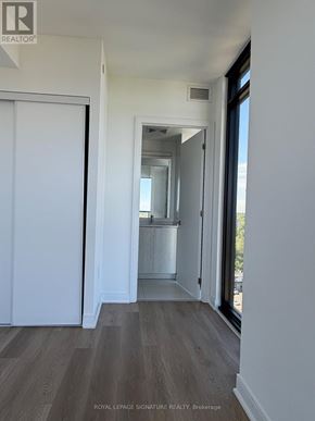 Mississauga (Cooksville) condo for rent - A room with a view of a cityscape through a large window.