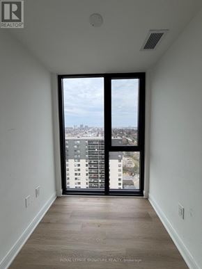 Mississauga (Cooksville) condo for rent - A room with a view of a cityscape through a large window.